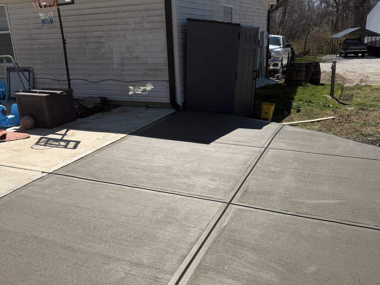 Finished concrete apron poured in front of an outbuilding door