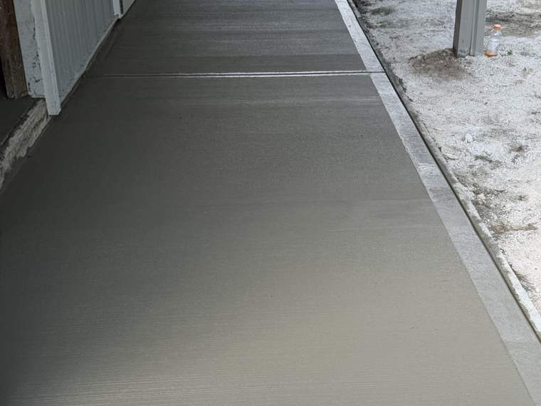 Concrete ramp poured up to a barn door opening
