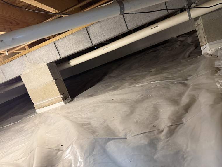 Crawlspace liner run around block piers and up the walls