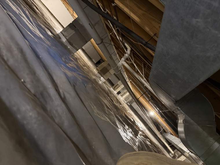 Crawlspace liner detailed around duct work and framing