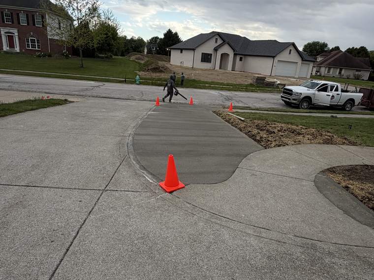 New concrete driveway apron poured out to the street