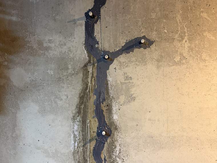 Foundation wall crack sealed with injection ports set along its length