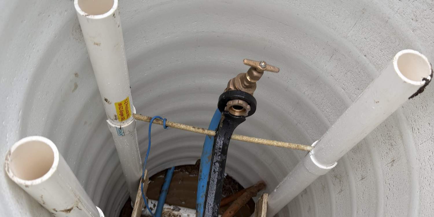 Inside a new water meter pit with the meter, valves and service lines set