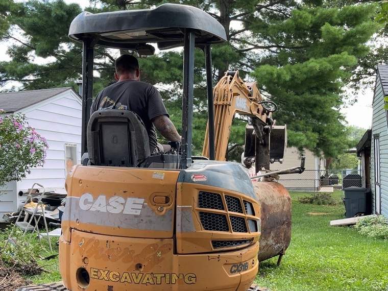 Sterling's operator running a compact excavator on a residential job site