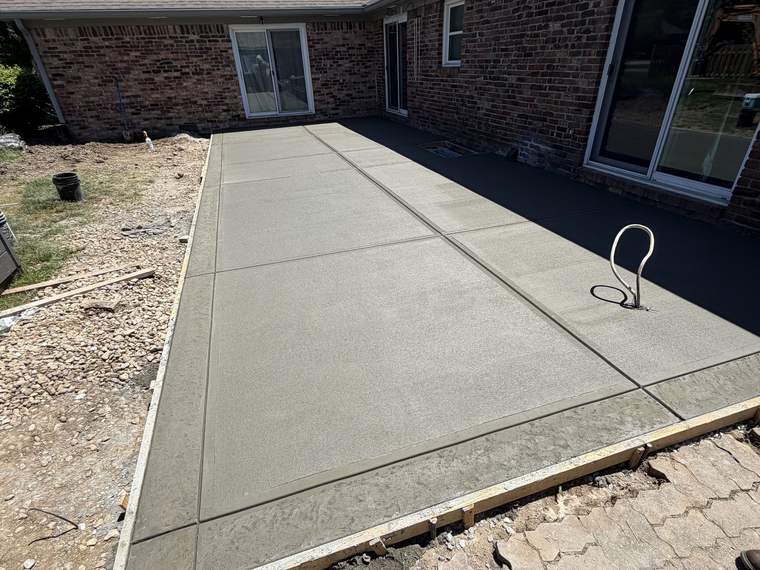 Finished concrete patio slab with the forms still in place