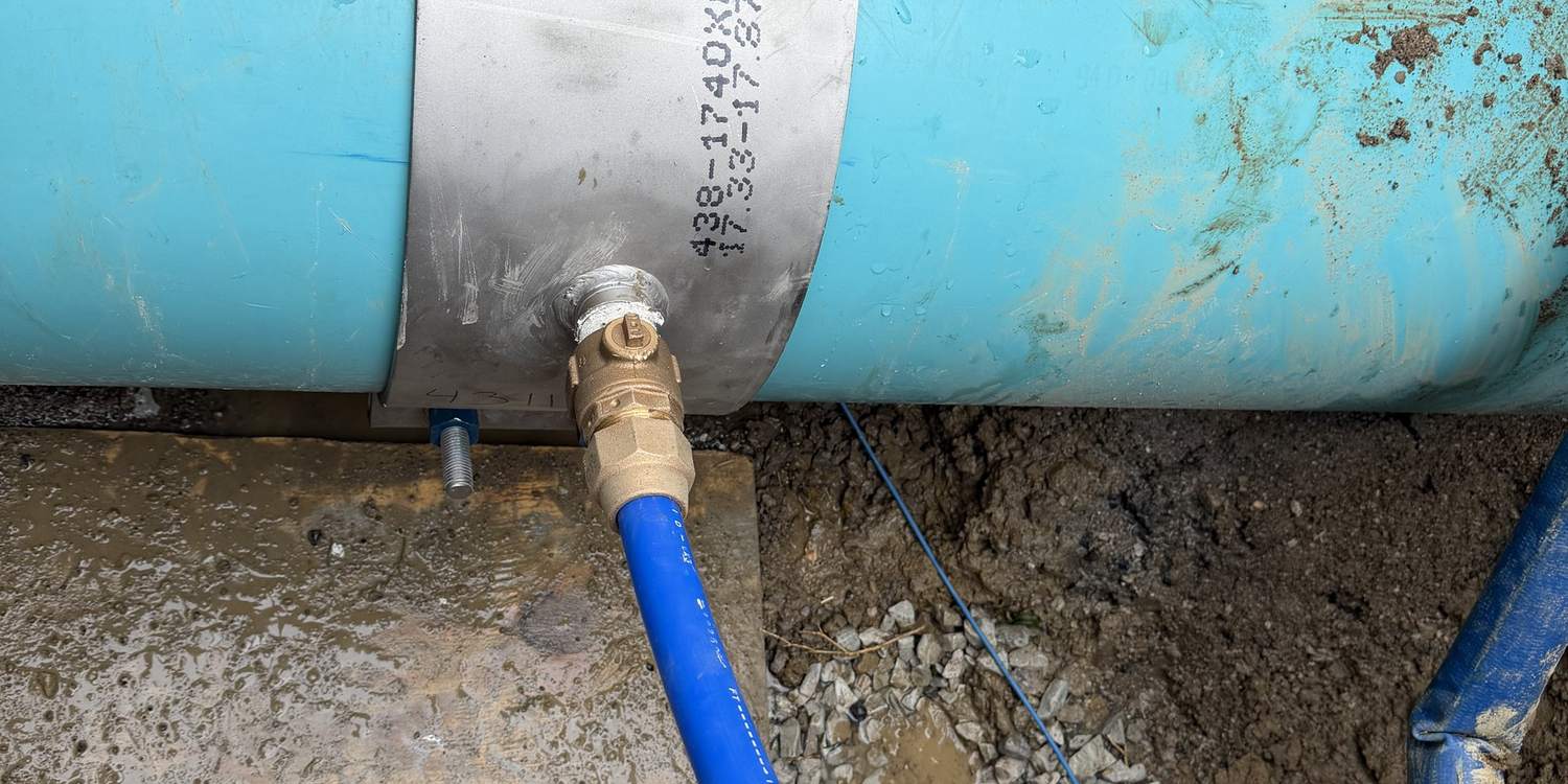 New water service line tapped into a main with a saddle and corporation stop